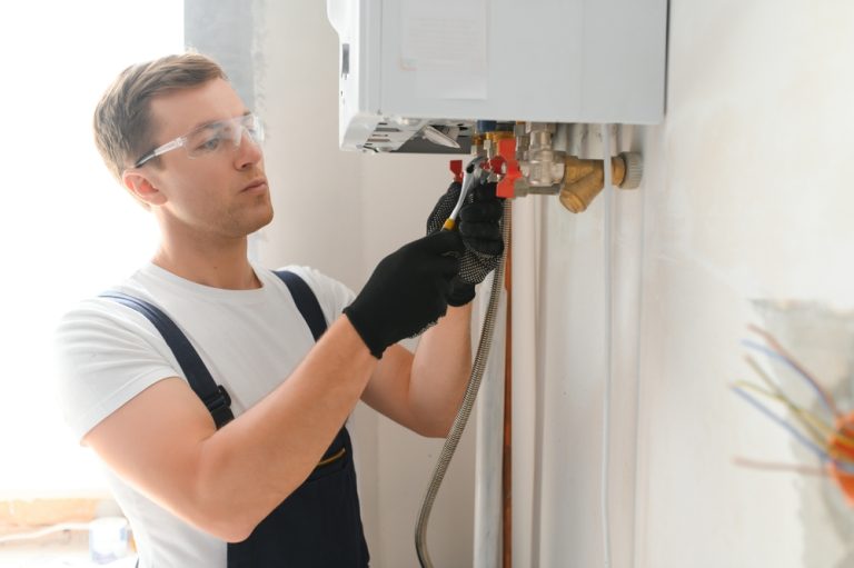 professional,plumber,checking,a,boiler,and,pipes,,boiler,service,concept.