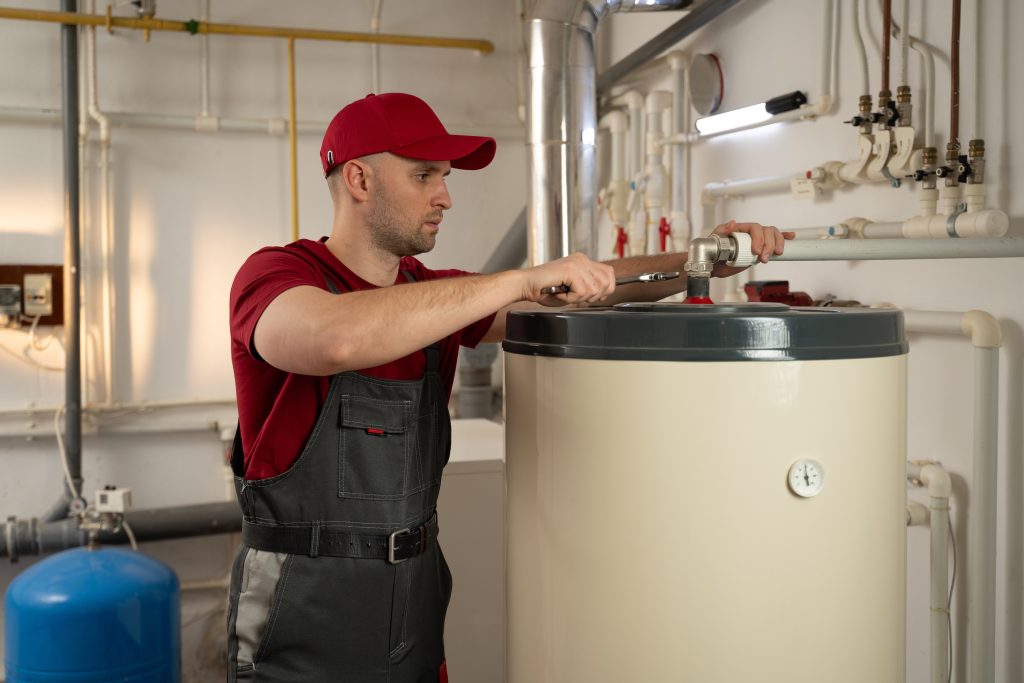 a,man,wearing,a,red,shirt,is,shown,fixing,a